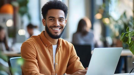 Sticker - Young Man Working on Laptop in Modern Office Space