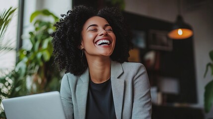 Canvas Print - Joyful Woman in Modern Workspace with Laptop