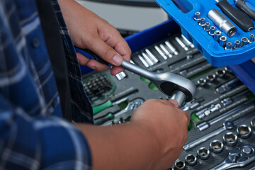 Sticker - Auto mechanic with torque wrench at automobile repair shop, closeup