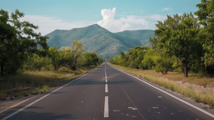 Asphalt Road Through Lush Green Hills