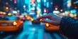 © kwanchaift - a hand pressing a crosswalk button, with bustling urban traffic and a blurred cityscape behind