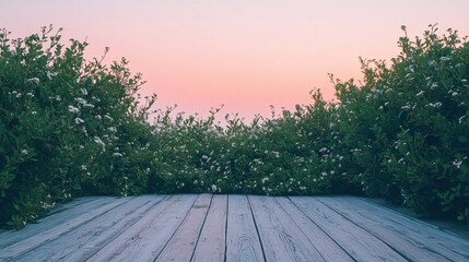 Sticker - Wooden planks framed by green bushes with white flowers against a pink sunset sky.