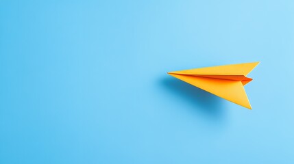 Yellow paper airplane flying on blue background.