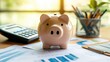 © Boonnam Burart - A piggy bank on a cluttered office desk, surrounded by financial documents and a calculator, symbolizing financial planning.