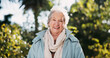 © KayExam/peopleimages.com - Portrait, smile and senior woman outdoor for wellness, health or life insurance in nature. Face, retirement and happy elderly person at garden for relax, fresh air or laughing in winter in Australia