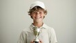 © JAYDA RIN - Young golfer smiling brightly after receiving a golf trophy at a junior competition   youth golf success, achievement joy