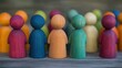 © tashechka - A diverse group of colorful wooden people figurines stands closely together, highlighting their bright colors and smooth textures in natural light