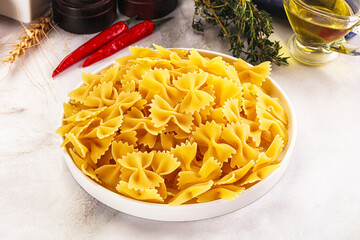 Canvas Print - Raw dry Italian pasta - farfalle