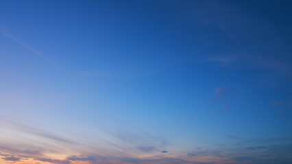 Peaceful sky over horizon. Nature sunset time. Purple fluffy clouds and blue sky. Timelapse.