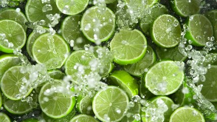 Fototapete - Super Slow Motion Shot of Splashing Fresh Limes . Filmed on High Speed Cinematic Camera at 1000fps .
