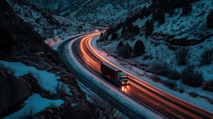 Sticker - A truck navigates a winding road through a snowy landscape at dusk, creating light trails.