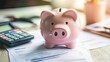 © sarun - A well-worn pink piggy bank sitting on a desk, surrounded by financial documents and a calculator, symbolizing personal savings goals.