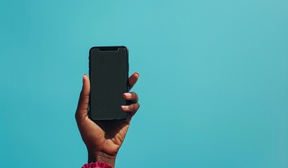 Female hands holding smartphone with blank screen on blue background, mockup