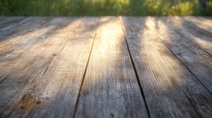 Poster - A sunlit wooden surface with a soft focus on greenery in the background.