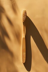 Wall Mural - A wooden toothbrush sits on a table, ready for use