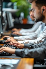 A group of men working on computers in an office setting