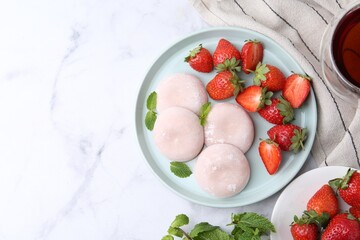 Canvas Print - Delicious mochi with strawberries and mint on white marble table, top view. Space for text