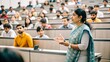 © Htet Wai Phyo - An Indian female professor giving a lecture to university students in a large lecture hall, emphasizing higher education