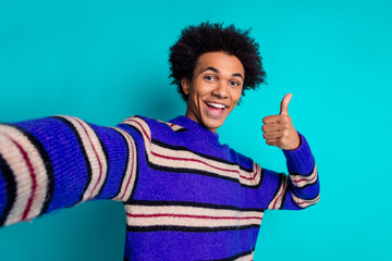 Sticker - Photo of optimistic man guy with wavy hairstyle dressed knitwear sweater making selfie showing thumb up isolated on blue color background