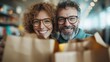 ©  Jovaduplex - A joyful couple with curly hair and glasses, holding shopping bags while standing in a bright, modern store environment, conveying happiness and companionship.