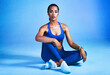 © Frank Coop/peopleimages.com - Fitness, floor and portrait of woman on blue background for health, wellness and active in studio. Personal trainer, yoga instructor and isolated person for exercise, training and workout for gym