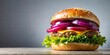 © suchetpong - Hamburger with red onion on top viewed from below