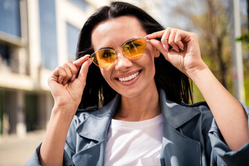 Canvas Print - Photo of grinning pretty lady dressed grey jacket dark eyewear enjoying sunshine outdoors town street