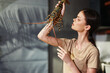 © SHOTPRIME STUDIO - Woman holding lobster in front of window, seafood concept, fresh catch of the day in kitchen setting