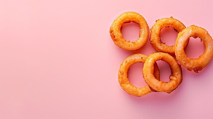 Wall Mural - Fried onion rings on a pink background