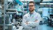 © Roodic - A man in a white lab coat stands in front of a lab bench with his arms crossed