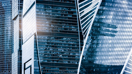 Poster - Glass buildings with cloudy blue sky background, reflective skyscrapers, business office buildings.