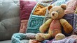 © Alexander - Multi colored hand knitted pillow with careless phrases and teddy bear
