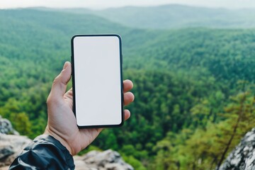 A hand holds a blank-screen mobile phone on a mountain cliff, with a  forest and sky in the background,generative ai