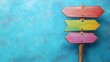 © Creative Art7 - a wooden signpost with colorful arrows pointing in different directions on a blue background, symbolizing multiple options and choice concepts