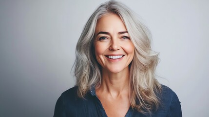 Wall Mural - A woman with short brown hair smiles brightly at the camera.