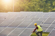 © RooM The Agency - Portrait of an engineer working on solar panels at a solar powered station, Thailand