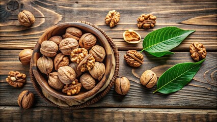 High angle view of fresh walnut kernels on wooden table with leaves, vintage bowl with whole walnut