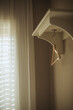 © RooM The Agency - Close-up of a single wooden coathanger hanging under a shelf