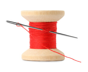 spool of red sewing thread with needle isolated on white