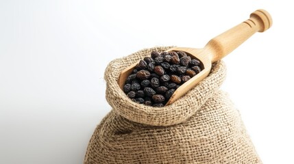 Raisin grain in wooden spoon closeup view