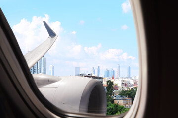 Wall Mural - Airplane taking off or landing, view on city from window