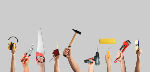 Poster - Hands of people with different tools on light grey background