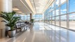 © Dumrongkait - A large airport terminal with a long, wide open lobby. The lobby is filled with chairs and a potted plant. The windows are large and allow for a lot of natural light to enter the space