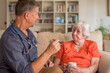 © Doodeez - A doctor, physician discusses a treatment care plan at home with an elderly, senior patient after receiving test results.