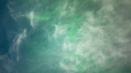 Wall Mural - looking up into the night sky at the stars, clouds, and aurora as they move through the sky. the aur