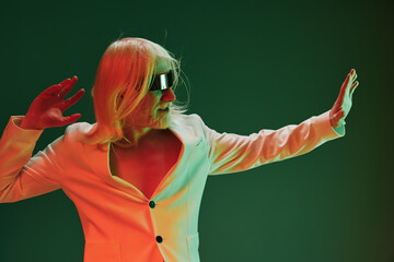 Futuristic man with long white hair in a stylish suit posed with a hand gesture against a green background The scene has a modern, vibrant aesthetic with a playful atmosphere