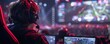 © Tanakrit - A gamer competes in an esports event, focused on the screen with a large audience and colorful lights in the background.