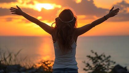 Joyful woman embracing the sunset in nature with open arms