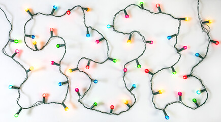 String of Christmas lights on white background. Colourful Christmas decoration.
