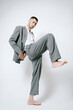 © Elina Leonova - Fashion man model in grey suit, barefoot, shoot in studio